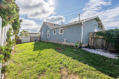 View of property exterior featuring a fenced backyard and stucco siding - 4702 50 Avenue, Cold Lake, AB - Outdoor