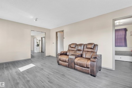 Living area with wood finished floors and baseboards - 4702 50 Avenue, Cold Lake, AB - Indoor