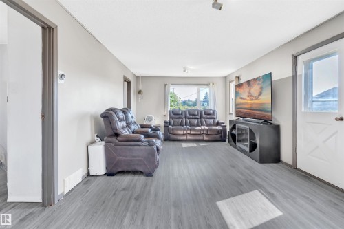 Living room featuring light wood-type flooring and baseboards - 4702 50 Avenue, Cold Lake, AB - Indoor