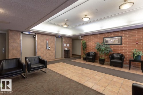 607 9917 110 Street, Edmonton, AB - Indoor Photo Showing Other Room With Fireplace