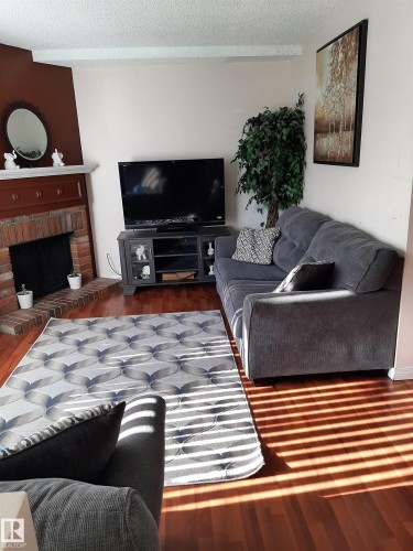 1068 Lakewood Road N, Edmonton, AB - Indoor Photo Showing Living Room With Fireplace