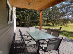 Deck with outdoor dining space and a yard - 