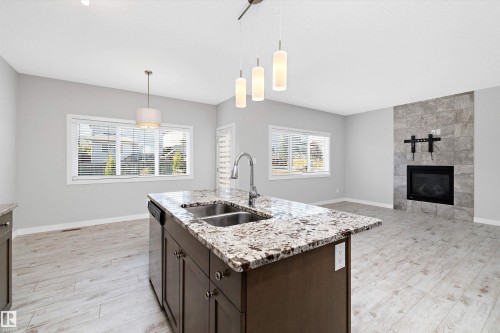 7310 Edgemont Way, Edmonton, AB - Indoor Photo Showing Kitchen With Fireplace With Double Sink