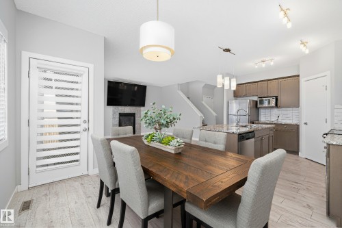 7310 Edgemont Way, Edmonton, AB - Indoor Photo Showing Dining Room With Fireplace