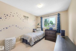 Bedroom featuring a textured ceiling and carpet flooring - 