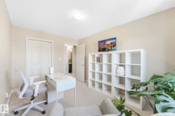 Carpeted office with a textured ceiling - 