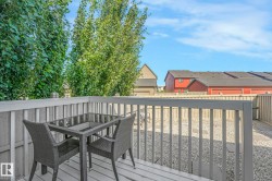 Deck featuring a residential view, outdoor dining area, and a fenced backyard - 