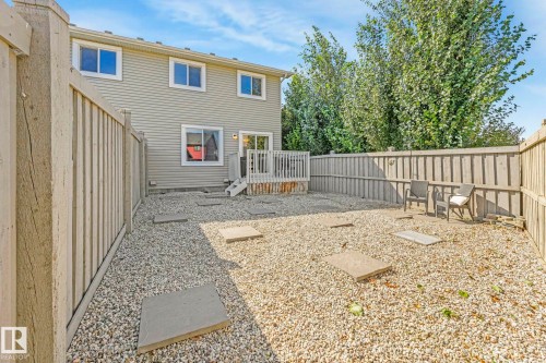 Rear view of property featuring a fenced backyard and a wooden deck - 6819 Cardinal Link, Edmonton, AB - Outdoor With Exterior