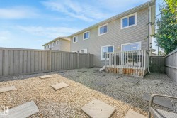 Rear view of property featuring a fenced backyard and a gate - 