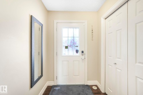Doorway to outside featuring baseboards and wood finished floors - 6819 Cardinal Link, Edmonton, AB - Indoor Photo Showing Other Room