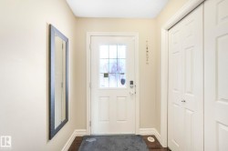 Doorway to outside featuring baseboards and wood finished floors - 