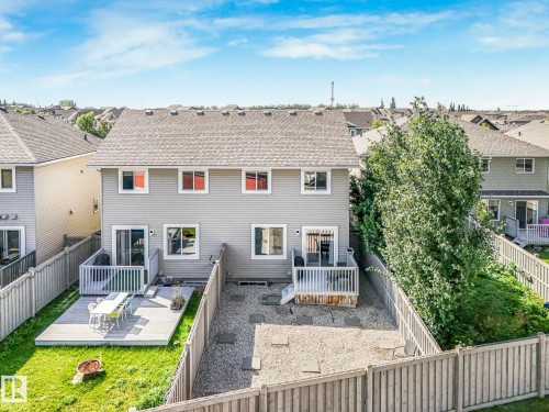 Back of house with a residential view, a fenced backyard, and a deck - 6819 Cardinal Link, Edmonton, AB - Outdoor With Deck Patio Veranda