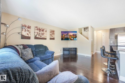 Living room featuring dark wood-style floors and a textured ceiling - 6819 Cardinal Link, Edmonton, AB - Indoor Photo Showing Living Room