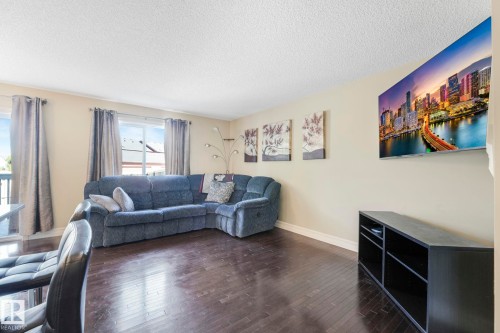 Living room with dark wood-style floors and a textured ceiling - 6819 Cardinal Link, Edmonton, AB - Indoor Photo Showing Living Room
