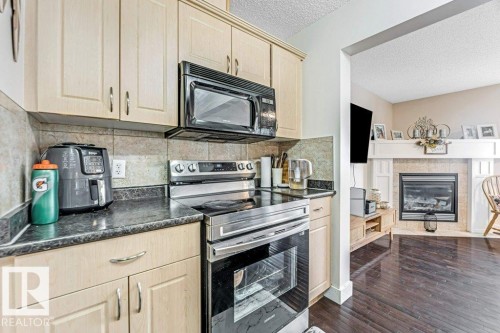 1137 37B Avenue, Edmonton, AB - Indoor Photo Showing Kitchen With Fireplace