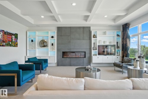 Carpeted living room featuring beamed ceiling, a tile fireplace, recessed lighting, and coffered ceiling - 11823 Saskatchewan Drive, Edmonton, AB - Indoor Photo Showing Living Room With Fireplace