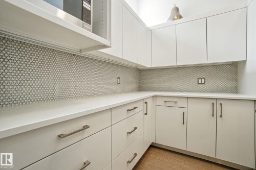 Butler's Pantry featuring white cabinets and tasteful backsplash - 11823 Saskatchewan Drive, Edmonton, AB - Indoor
