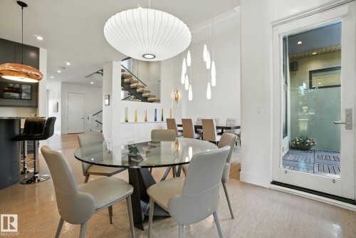 Dining space featuring stairway, recessed lighting, and light wood-type flooring - 11823 Saskatchewan Drive, Edmonton, AB - Indoor Photo Showing Dining Room