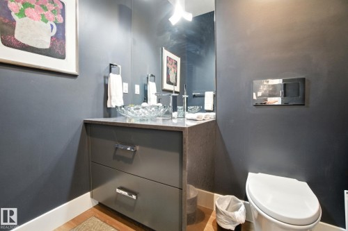 Half bath featuring vanity and light wood-type flooring - 11823 Saskatchewan Drive, Edmonton, AB - Indoor Photo Showing Bathroom