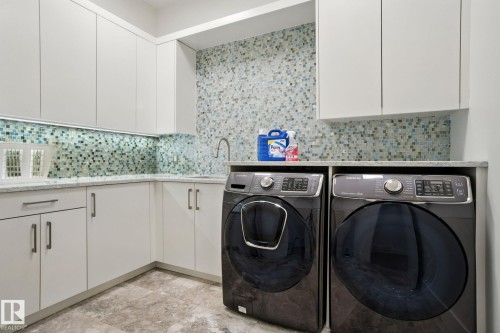 Laundry area with cabinet space and washer and dryer - 11823 Saskatchewan Drive, Edmonton, AB - Indoor Photo Showing Laundry Room