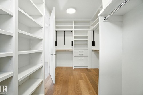Spacious closet with light wood-style floors - 11823 Saskatchewan Drive, Edmonton, AB - Indoor With Storage