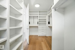 Spacious closet with light wood-style floors - 