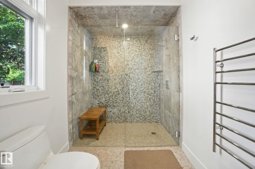 Full bath with plenty of natural light, a shower stall, and a towel warming rack - 11823 Saskatchewan Drive, Edmonton, AB - Indoor Photo Showing Bathroom