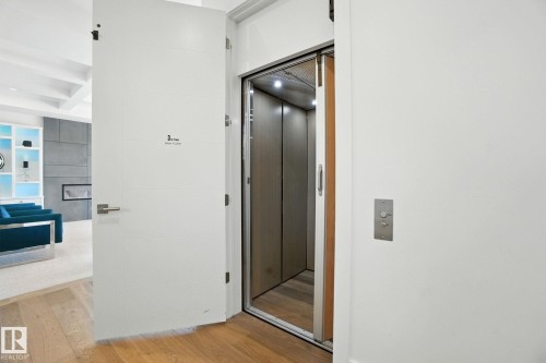 Corridor with light wood finished floors and elevator - 11823 Saskatchewan Drive, Edmonton, AB - Indoor Photo Showing Other Room