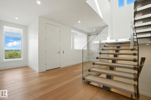 Stairs featuring wood finished floors and recessed lighting - 11823 Saskatchewan Drive, Edmonton, AB - Indoor Photo Showing Other Room