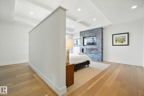 Bedroom featuring light wood-style floors, coffered ceiling, beam ceiling, and recessed lighting - 11823 Saskatchewan Drive, Edmonton, AB - Indoor