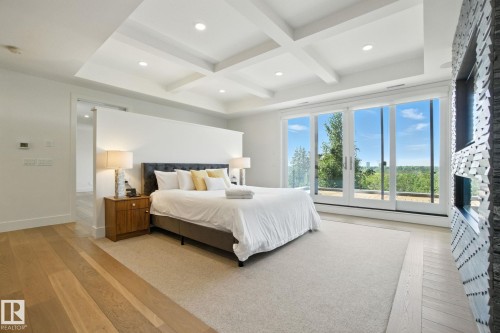 Bedroom with light wood finished floors, coffered ceiling, beam ceiling, and recessed lighting - 11823 Saskatchewan Drive, Edmonton, AB - Indoor Photo Showing Bedroom