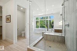Bathroom with a shower stall, light tile patterned flooring, a soaking tub, and recessed lighting - 