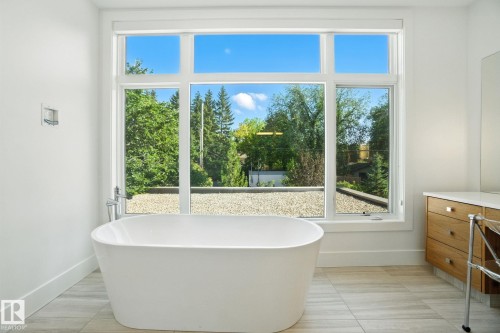 Bathroom with vanity, a freestanding tub, and plenty of natural light - 11823 Saskatchewan Drive, Edmonton, AB - Indoor Photo Showing Bathroom