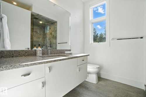 Bathroom with vanity, a marble finish shower, and concrete floors - 11823 Saskatchewan Drive, Edmonton, AB - Indoor Photo Showing Bathroom