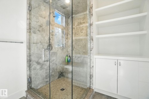 Full bath with a marble finish shower - 11823 Saskatchewan Drive, Edmonton, AB - Indoor Photo Showing Bathroom