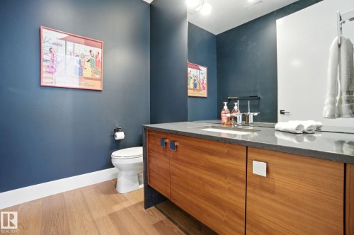 Half bathroom with vanity and light wood-style flooring - 11823 Saskatchewan Drive, Edmonton, AB - Indoor Photo Showing Bathroom