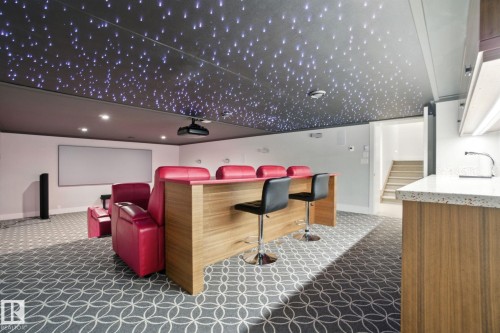 Cinema featuring a community bar, dark colored carpet, and recessed lighting - 11823 Saskatchewan Drive, Edmonton, AB - 