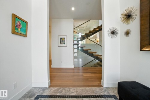 Stairway with baseboards and wood finished floors - 11823 Saskatchewan Drive, Edmonton, AB - Indoor Photo Showing Other Room