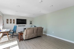 Living area with a desk, wood finished floors, and recessed lighting - 