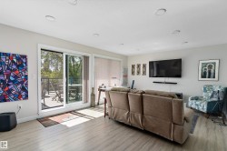 Living area with light wood-style floors and recessed lighting - 