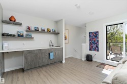 Bar featuring light wood-style floors, modern cabinets, and open shelves - 