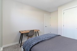 Carpeted bedroom with baseboards and a closet - 