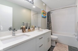 Full bathroom with shower / bath combination with curtain and double vanity - 