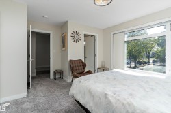 Bedroom with light carpet and baseboards - 