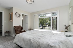 Bedroom with light colored carpet and baseboards - 