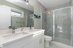 Bathroom with double vanity and a stall shower - 