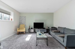 Carpeted living area with baseboards - 