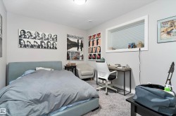 Bedroom with light colored carpet and a textured ceiling - 