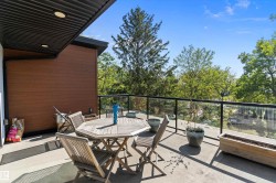 Balcony featuring outdoor dining space and view of scattered trees - 