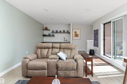 Living room with light wood finished floors and bar with sink - 